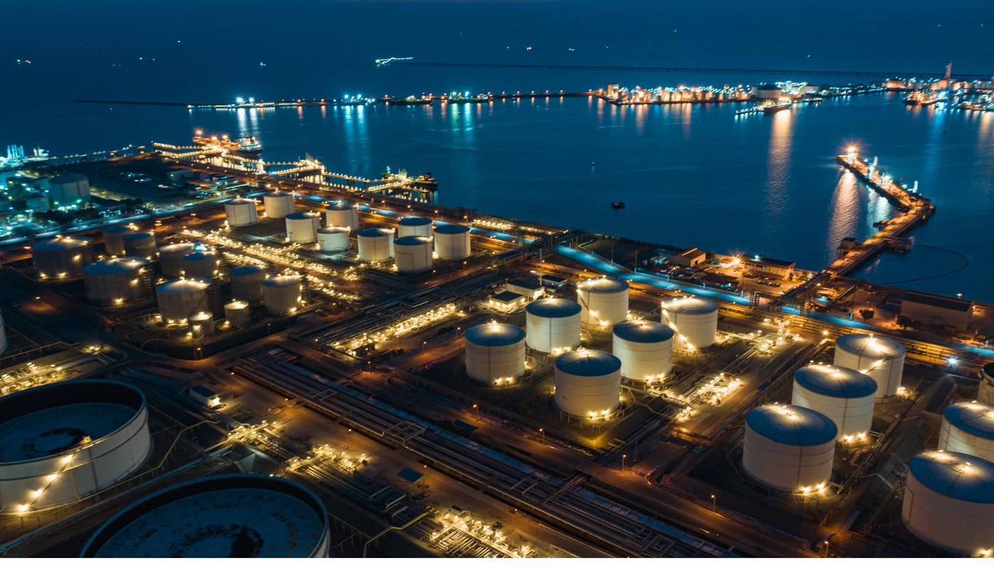 Aerial view of a coastal fuel storage terminal at night